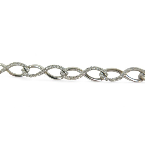 216 - An 18ct white gold diamond bracelet, 18.5cm long, 6mm wide, 11.8grams.