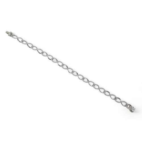 216 - An 18ct white gold diamond bracelet, 18.5cm long, 6mm wide, 11.8grams.