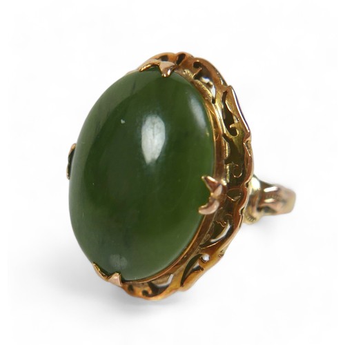 132 - A yellow gold jade ring, size N, head size 24 by 11 by 19mm, 5.9g.