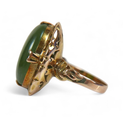 132 - A yellow gold jade ring, size N, head size 24 by 11 by 19mm, 5.9g.