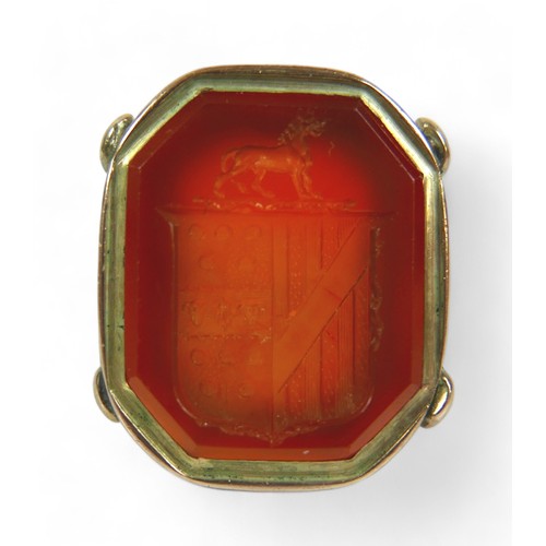 182 - Two Georgian yellow metal fob seals, comprising a Carnelian fob converted into a gents ring, impress... 