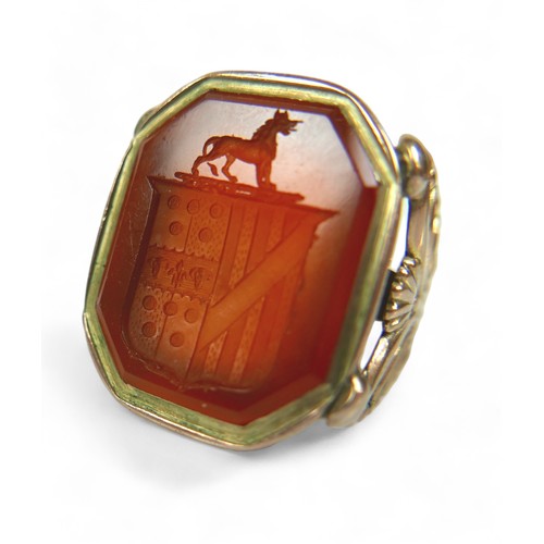 182 - Two Georgian yellow metal fob seals, comprising a Carnelian fob converted into a gents ring, impress... 