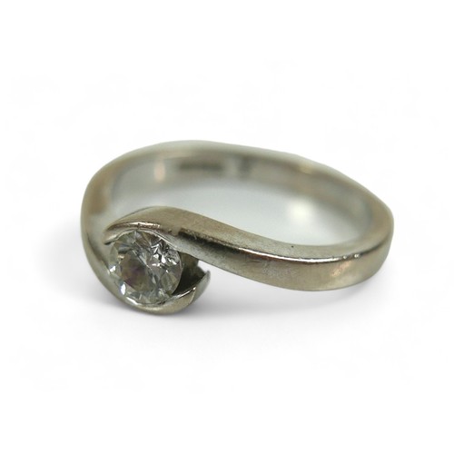 224 - An 18ct white gold and diamond solitaire ring, the brilliant cut stone 0.23ct, in crossover setting,... 