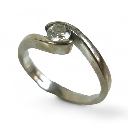 224 - An 18ct white gold and diamond solitaire ring, the brilliant cut stone 0.23ct, in crossover setting,... 