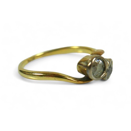 214 - An 18ct yellow gold ring, set with two brilliant cut diamonds, each 3.5mm, 0.17ct, in crossover sett... 