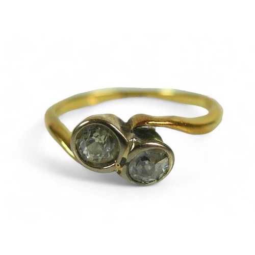 214 - An 18ct yellow gold ring, set with two brilliant cut diamonds, each 3.5mm, 0.17ct, in crossover sett... 