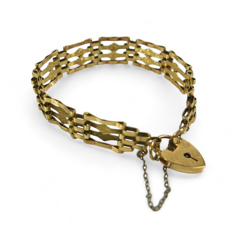 185 - A 9ct gold bar gate bracelet with heart shaped lock and central textured bands, 10.6g.