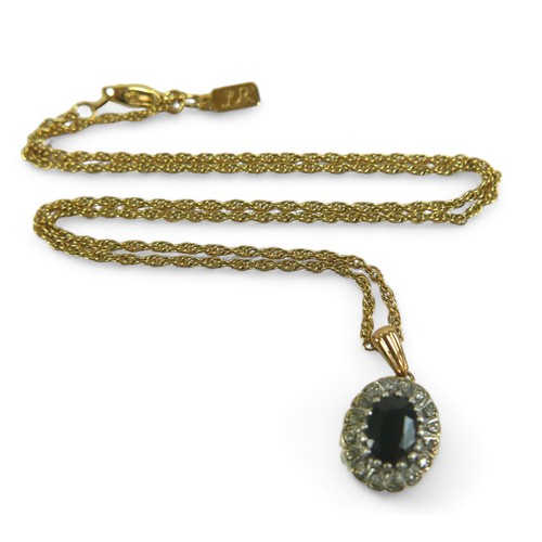 186 - An oval sapphire and diamond flowerhead pendant on gold chain, the chain testing as 9ct, 2.8g, mount... 