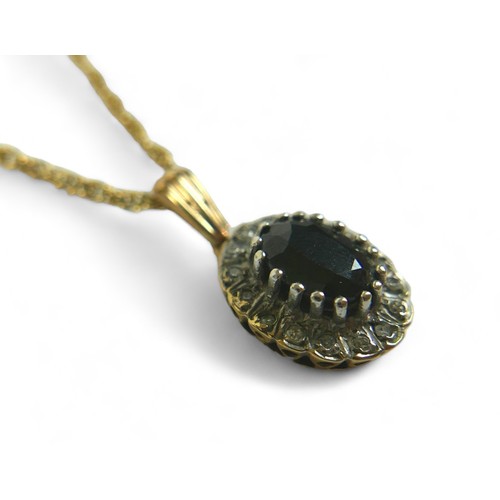 186 - An oval sapphire and diamond flowerhead pendant on gold chain, the chain testing as 9ct, 2.8g, mount... 