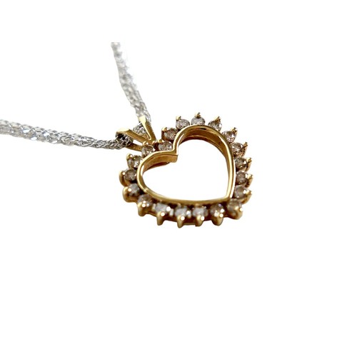 209 - A 15ct gold and diamond heart shaped pendant, set with twenty brilliant cut diamonds, on a 15ct whit... 