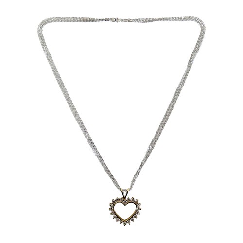 209 - A 15ct gold and diamond heart shaped pendant, set with twenty brilliant cut diamonds, on a 15ct whit... 