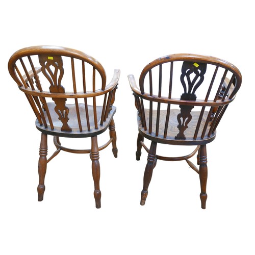 564 - An associated pair of Windsor chairs, pierced back slats, elm seats, turned legs joined by a crinoli... 