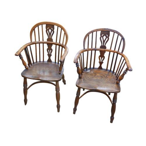 564 - An associated pair of Windsor chairs, pierced back slats, elm seats, turned legs joined by a crinoli... 