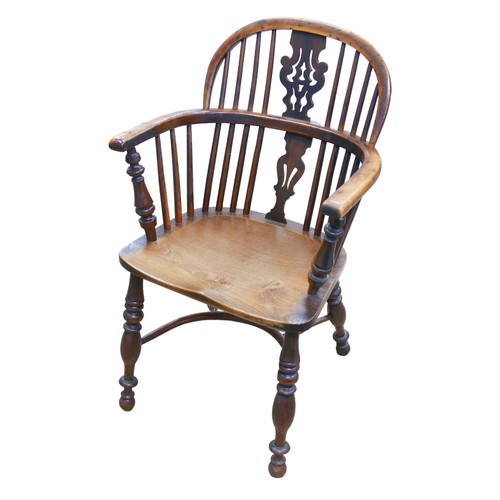 565 - A 19th century yew and elm Windsor chair, pierced back slat, elm seat,  turned legs joined by a crin... 