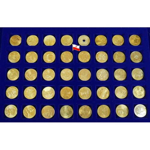 114 - Three coin cases, containing one hundred gilt world metal coins, case size 38 by 3 by 26cm. (3)