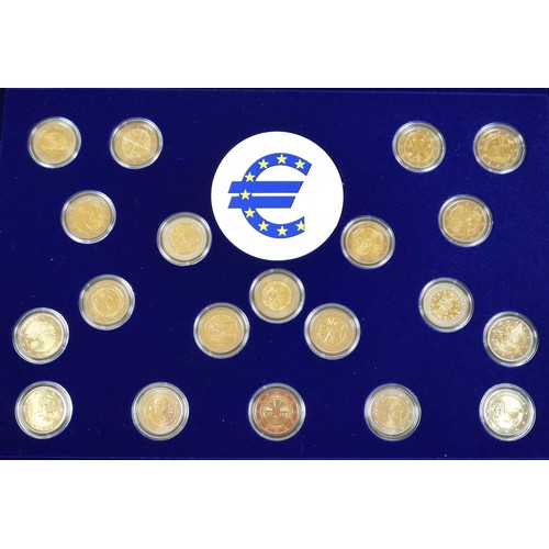 114 - Three coin cases, containing one hundred gilt world metal coins, case size 38 by 3 by 26cm. (3)