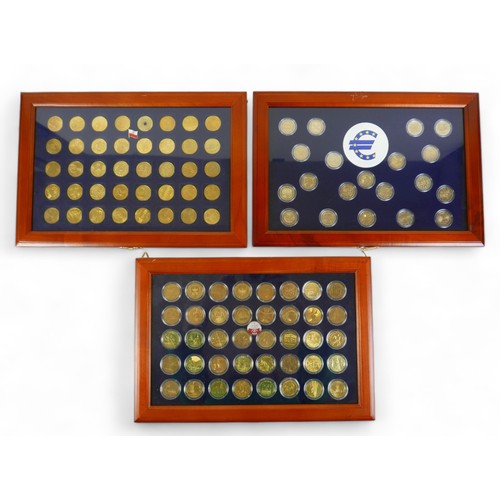 114 - Three coin cases, containing one hundred gilt world metal coins, case size 38 by 3 by 26cm. (3)