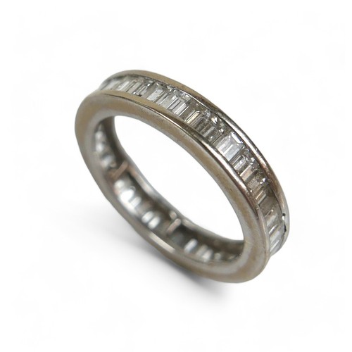 91 - An 18ct white gold and diamond full eternity ring, set with thirty six baguette cut stones, approxim... 