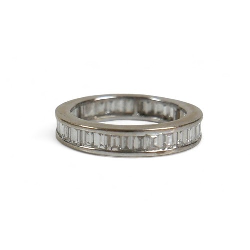 91 - An 18ct white gold and diamond full eternity ring, set with thirty six baguette cut stones, approxim... 