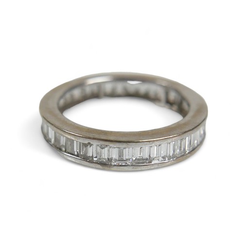 91 - An 18ct white gold and diamond full eternity ring, set with thirty six baguette cut stones, approxim... 