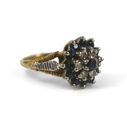 81 - A 15ct gold, diamond and sapphire flowerhead ring, with central sapphire, six diamonds and outer rin... 