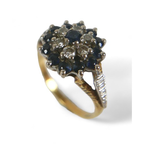 81 - A 15ct gold, diamond and sapphire flowerhead ring, with central sapphire, six diamonds and outer rin... 