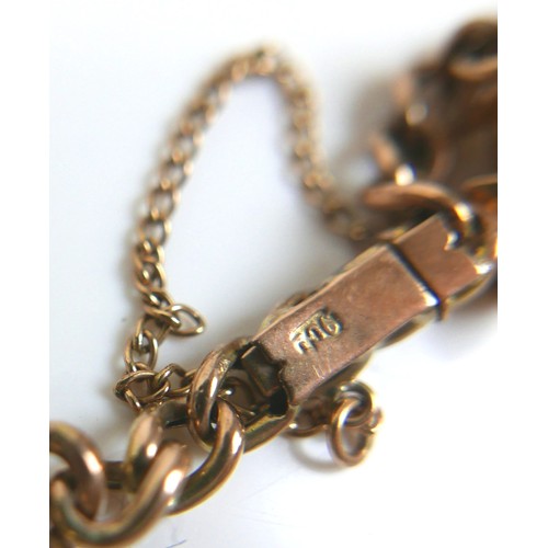 86 - A 9ct gold charm bracelet, with push clasp and safety chain, fourteen gold charms, including a horse... 