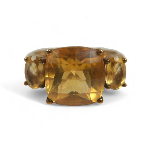 64 - A group of three 9ct gold ladies dress rings, comprising a three stone citrine ring, the central, cu... 