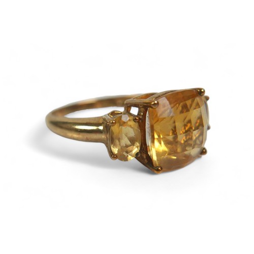 64 - A group of three 9ct gold ladies dress rings, comprising a three stone citrine ring, the central, cu... 