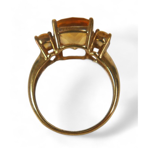 64 - A group of three 9ct gold ladies dress rings, comprising a three stone citrine ring, the central, cu... 