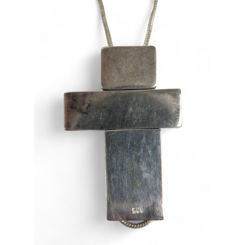 59 - A silver box link necklace suspending a Gucci silver three section asymmetrical cross shaped pendant... 