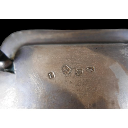 7 - A George I silver tray, of square form with incuse corners and reeded rim, raised on four hoof feet,... 