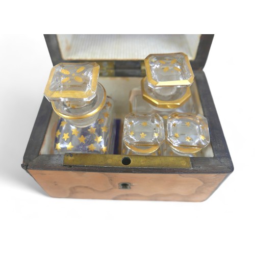 23 - A 19th century satinwood box with four glass stoppered bottles within, star gilt design, plus oval f... 