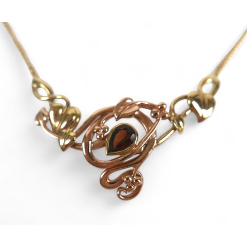 56 - An Art Nouveau style 9ct gold and pear-shaped garnet set pendant necklace, 7.2g.