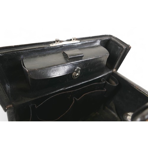 387 - A late Victorian leather fitted travel case with a fitted interior housing bottles and brushes, with... 