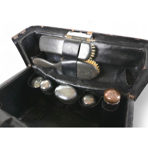 387 - A late Victorian leather fitted travel case with a fitted interior housing bottles and brushes, with... 