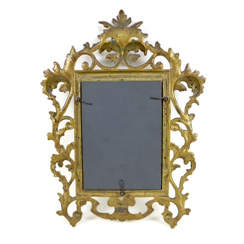 283 - A Victorian gilt decorated cast iron frame, fitted with a bevelled mirror plate, the frame with cast... 