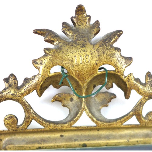 283 - A Victorian gilt decorated cast iron frame, fitted with a bevelled mirror plate, the frame with cast... 