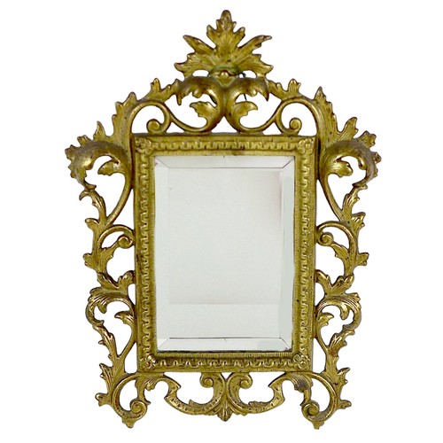 283 - A Victorian gilt decorated cast iron frame, fitted with a bevelled mirror plate, the frame with cast... 