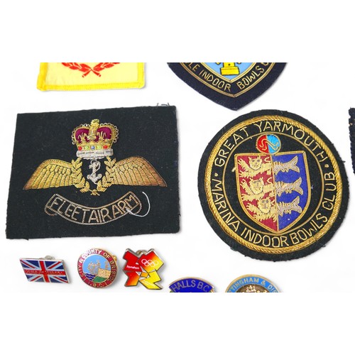 276 - A collection of pin and cloth badges, including some militaria, 'Fleet Air Arm', as well as a number... 