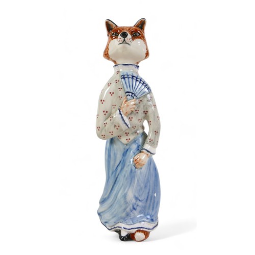 217 - A Cinque Ports pottery 'Felicity Fox' figurine, wearing a light blue skirt and holding a fan, rare c... 