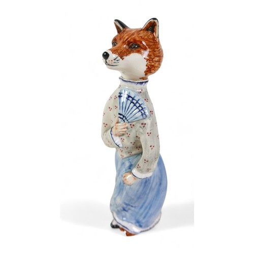 217 - A Cinque Ports pottery 'Felicity Fox' figurine, wearing a light blue skirt and holding a fan, rare c... 