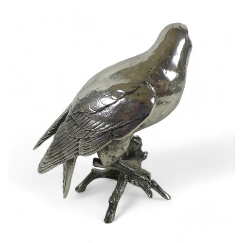 262 - A Keith Sherwin nickel resin sculpture of a falcon, perched on a branch, 17.5 by 20 by 24cm high.