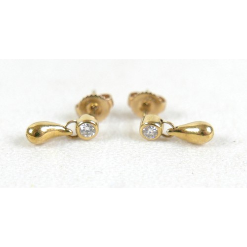 100 - A pair of diamond and gold earrings, each set with single diamond solitaire of approximately 0.1ct a... 