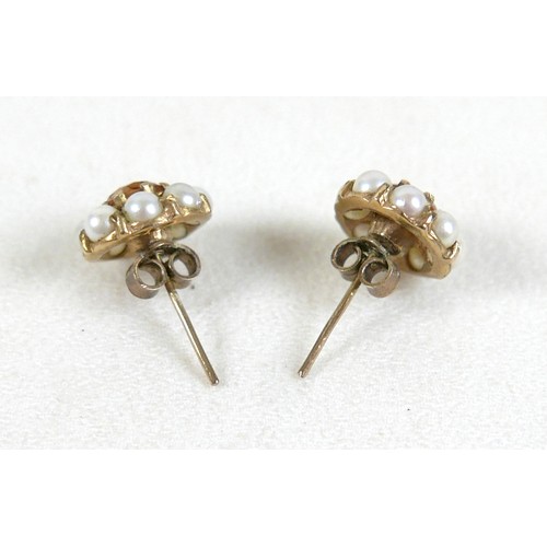 100 - A pair of diamond and gold earrings, each set with single diamond solitaire of approximately 0.1ct a... 