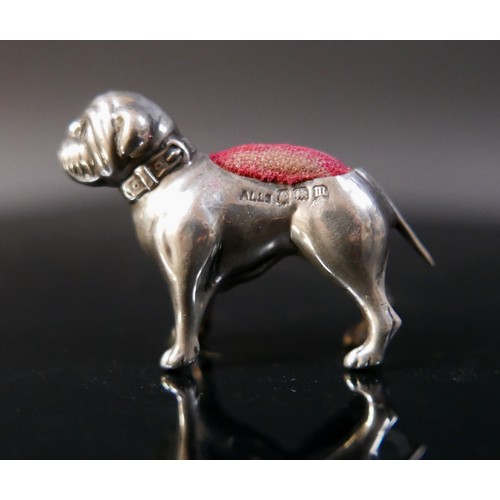 21 - A silver pug dog pin cushion, Adie & Lovekin Ltd, Birmingham 1911/12, 4 by 1 by 3cm tall. 5.5gs/0.18... 