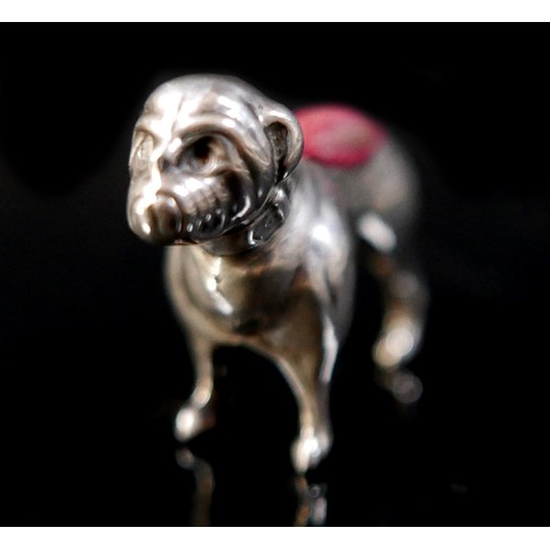 21 - A silver pug dog pin cushion, Adie & Lovekin Ltd, Birmingham 1911/12, 4 by 1 by 3cm tall. 5.5gs/0.18... 