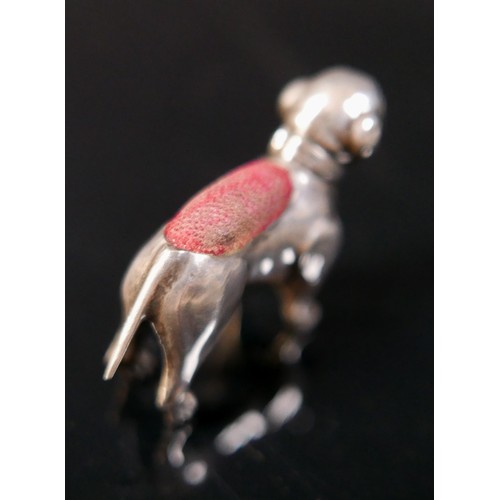 21 - A silver pug dog pin cushion, Adie & Lovekin Ltd, Birmingham 1911/12, 4 by 1 by 3cm tall. 5.5gs/0.18... 