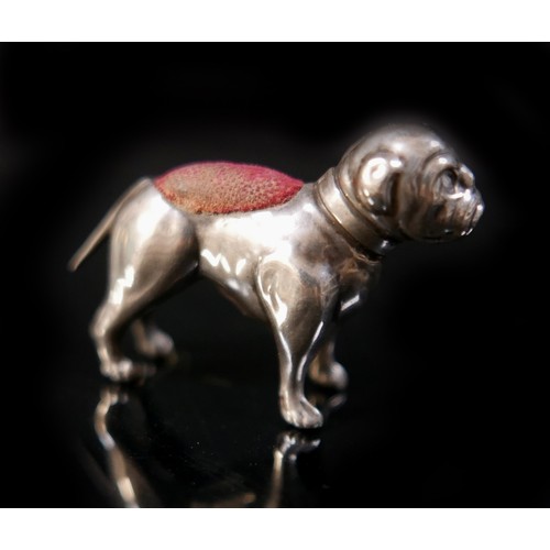 21 - A silver pug dog pin cushion, Adie & Lovekin Ltd, Birmingham 1911/12, 4 by 1 by 3cm tall. 5.5gs/0.18... 