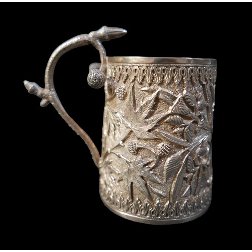 24 - A eastern white metal tankard and a vesta case, both with foliate decoration, tankard 11 by 6.5 by 1... 